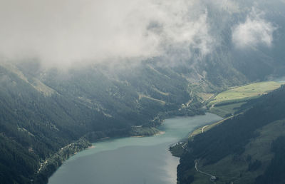 Scenic view of river amidst mountains against sky