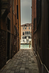 Narrow alley amidst buildings in city