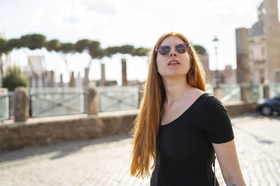 Young woman admiring city architecture