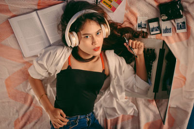 High angle portrait of young woman holding text