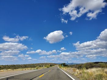 Empty road along countryside landscape