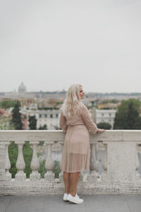 Full length of woman standing against sky