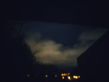 Low angle view of illuminated building against sky at night