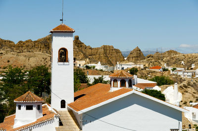 View of church and buildings against sky