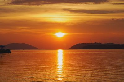 Scenic view of sea against romantic sky at sunset