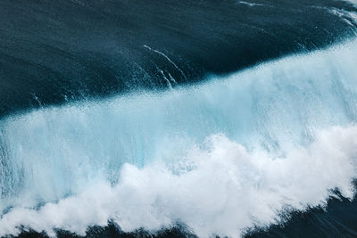 High angle view of waves splashing in sea