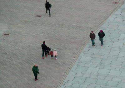 High angle view of people walking on road