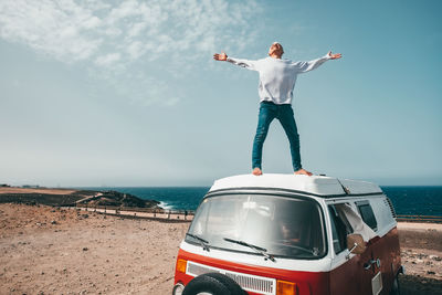 Full length of man standing by sea against sky