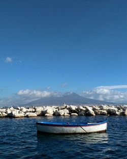 Naples, boat moored against vesuvius and blue sky