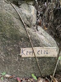 High angle view of text on rock