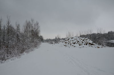 Snow covered landscape against sky