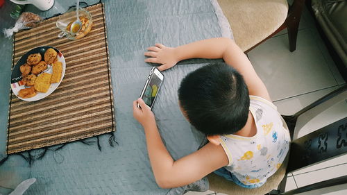 High angle view of boy using a smart phone