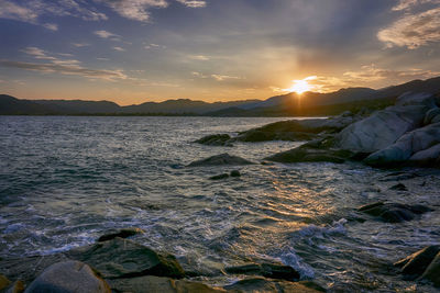 Scenic view of sea against sky at sunset