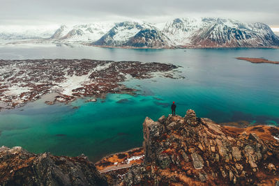 Scenic view of lake by mountains against sky