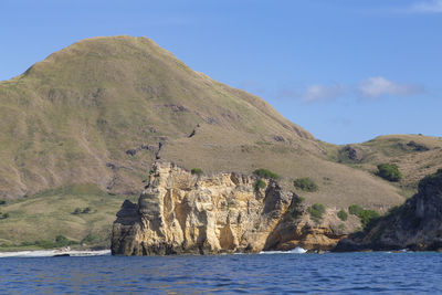 Scenic view of sea and mountains against sky