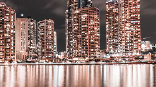 Reflection of illuminated buildings in water at night