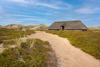 Panoramic image of a traditional house within the dunes of amrum, north sea, germany