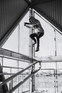 Low angle view of man jumping on railing