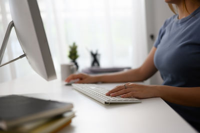 Midsection of man working on table