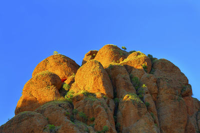Low angle view of rock formations against clear sky