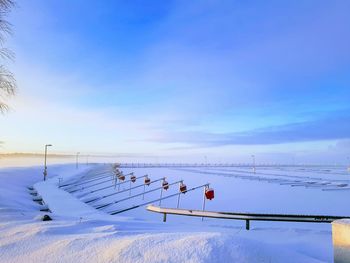 Scenic view of snow covered field against sky