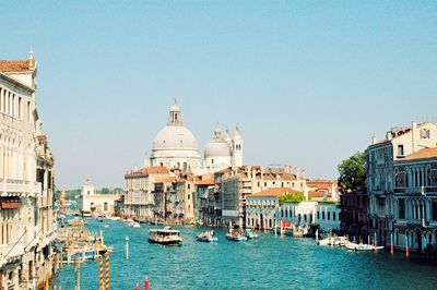 Boats in canal with buildings in background