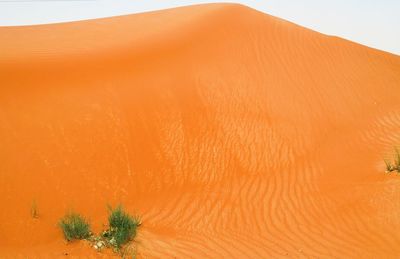 Scenic view of desert against orange sky