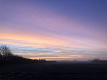 Scenic view of field against sky during sunset