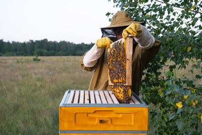 Rear view of woman standing on field