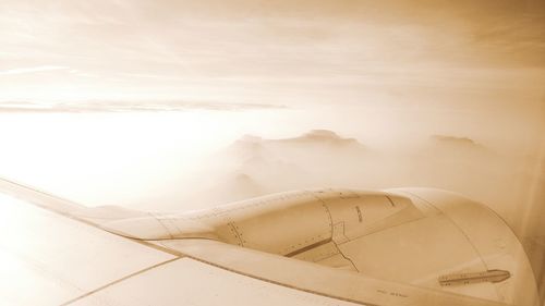 Close-up of airplane wing against sky
