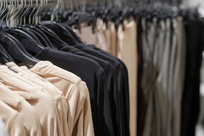 Casual black and beige clothes in the store