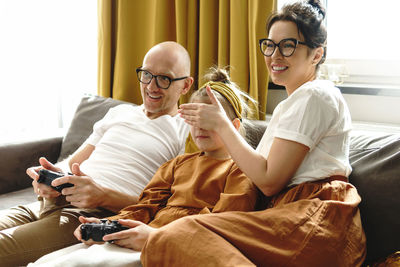 Father and daughter playing game at home