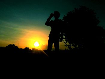 Silhouette of people at sunset