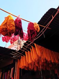 Low angle view of clothes drying on roof against sky