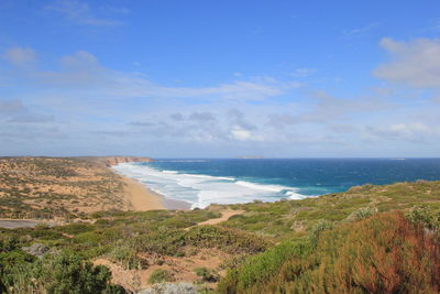 High angle view of calm beach below blue sky