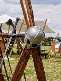 Reenactment helmet and sword on wooden structure