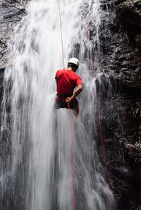 Red water splashing in waterfall