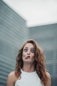 Portrait of young woman against blurred background