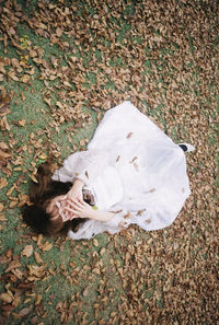 High angle view of woman lying down on land