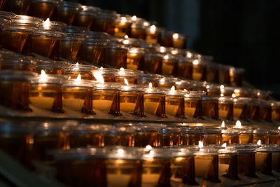 Close-up of illuminated candles on table