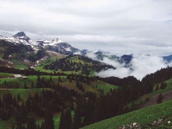 Scenic view of mountains against cloudy sky