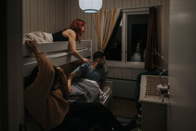 Frightened friends on bunkbed looking at ghost through window