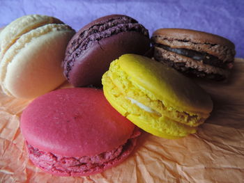 Close-up of colorful macaroons on wax paper