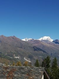 Scenic view of mountains against clear blue sky