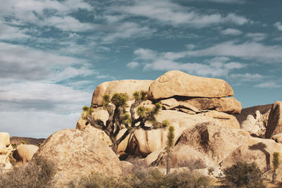 Rock formations on landscape against sky