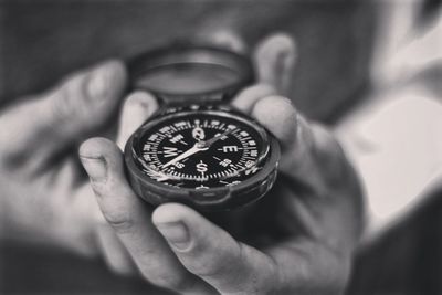 Close-up of person hand holding navigational compass