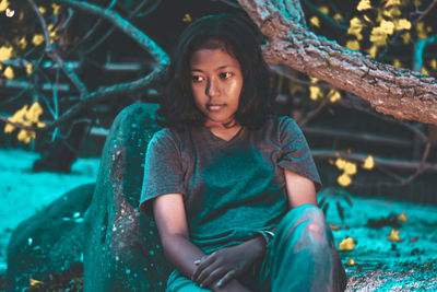 Portrait of woman sitting outdoors