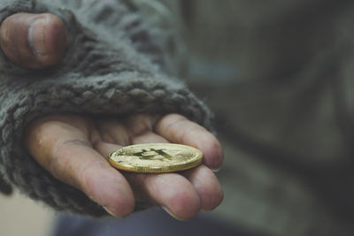 Close-up of hand holding bitcoin