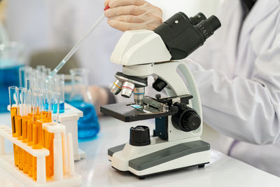 Midsection of scientist working in laboratory