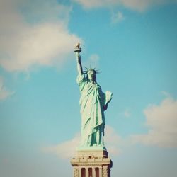 Low angle view of statue against cloudy sky